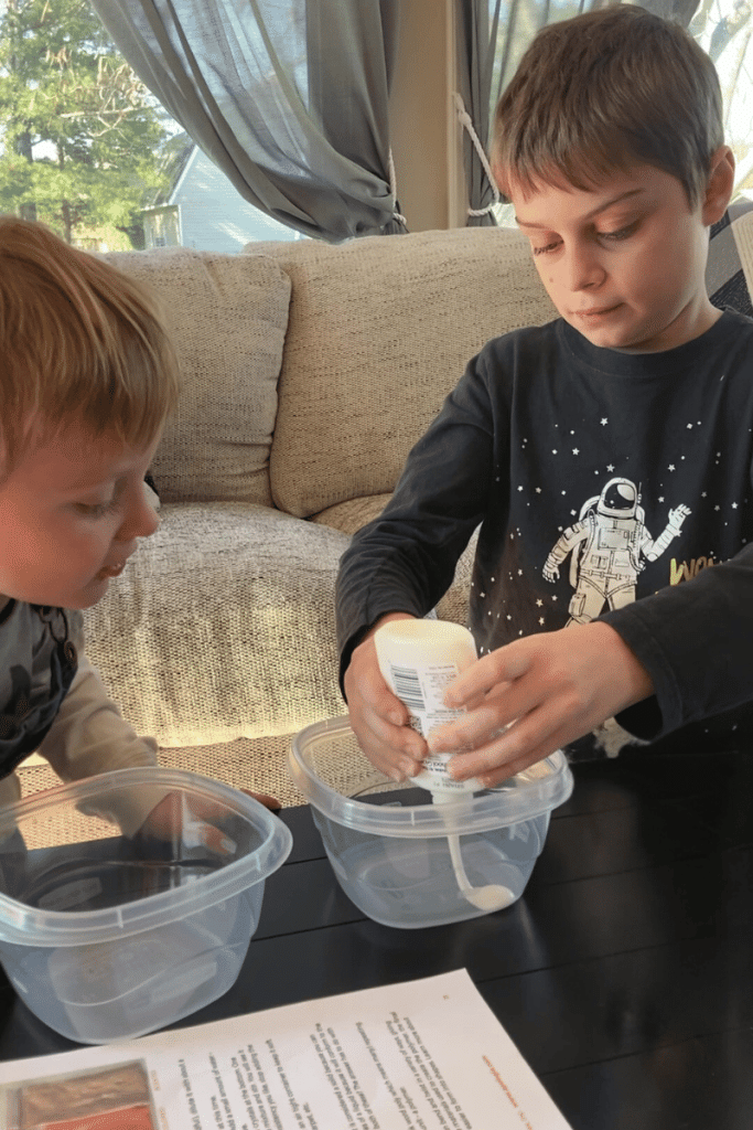 Pumpkin Thinking Putty Activity - two young children pouring glue into a bowl