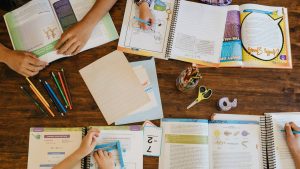 Homeschool curriculum open on a large table