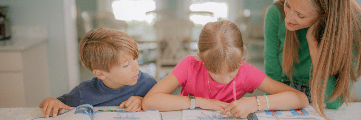 Homeschool mom helping son and daughter with school