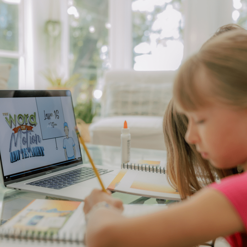 Homeschool students watching Bible curriculum video lessons at home