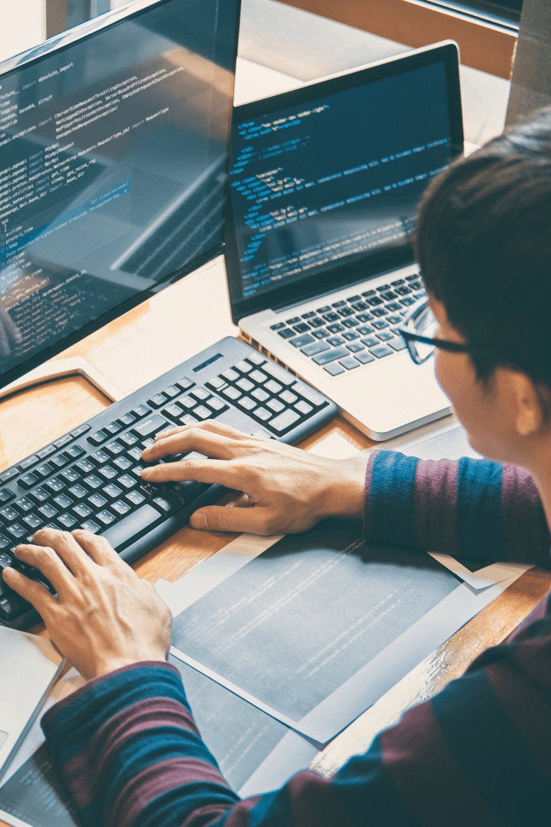 person coding on a computer