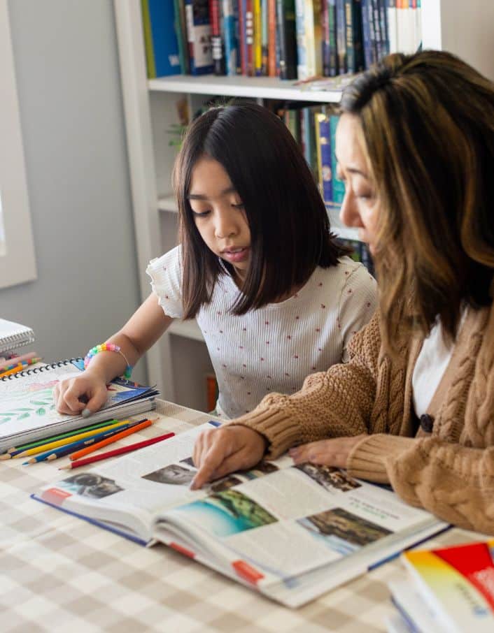 Homeschool mom with her daughter teaching Apologia science